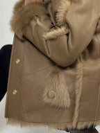 Beige women’s sheepskin coat with a fur collar