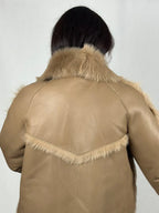 Beige women’s sheepskin coat with a fur collar