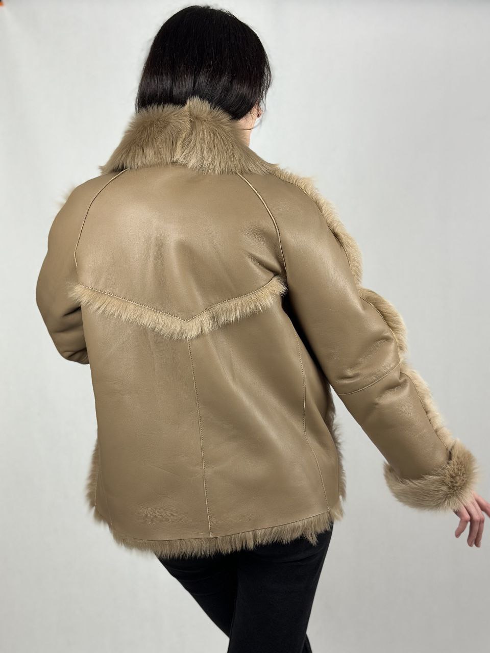 Beige women’s sheepskin coat with a fur collar