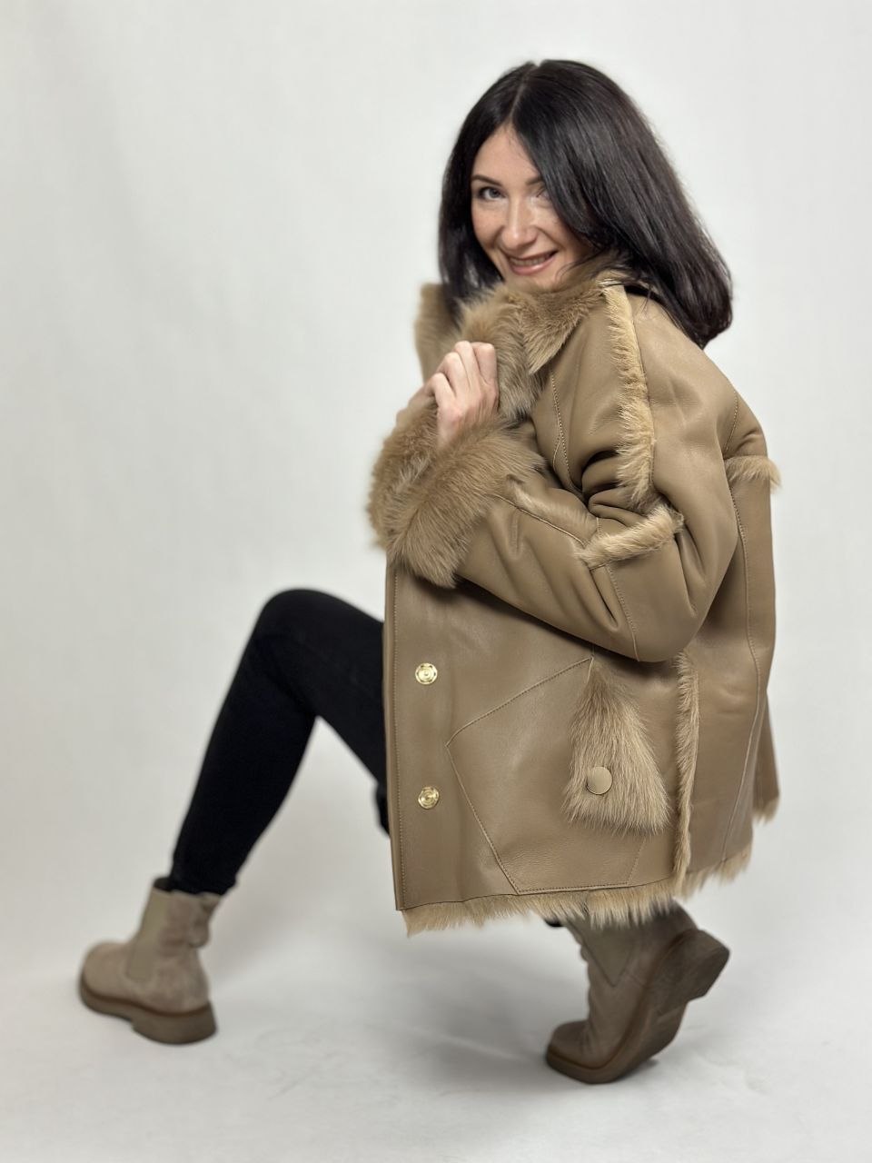 Beige women’s sheepskin coat with a fur collar
