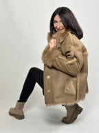 Beige women’s sheepskin coat with a fur collar