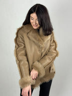 Beige women’s sheepskin coat with a fur collar
