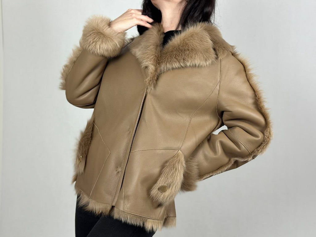 Beige women’s sheepskin coat with a fur collar