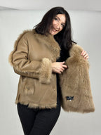 Beige women’s sheepskin coat with a fur collar
